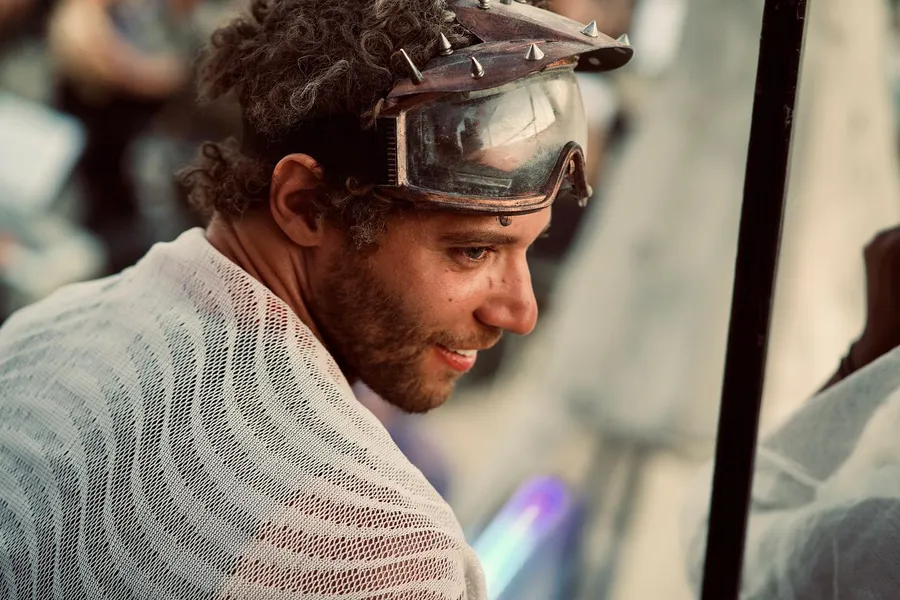 Close-up of a person with dusty goggles pushed up on their forehead