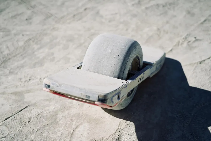 An oversized tape-dispenser sculpture rests on the dusty playa