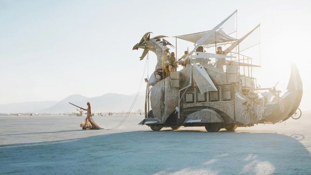Heavy Meta crossing the Black Rock Desert with a costumed handler holding its reins