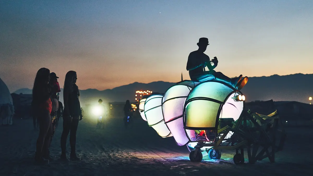 Shelly the Crab glowing at dusk on the Black Rock Desert while carrying an operator