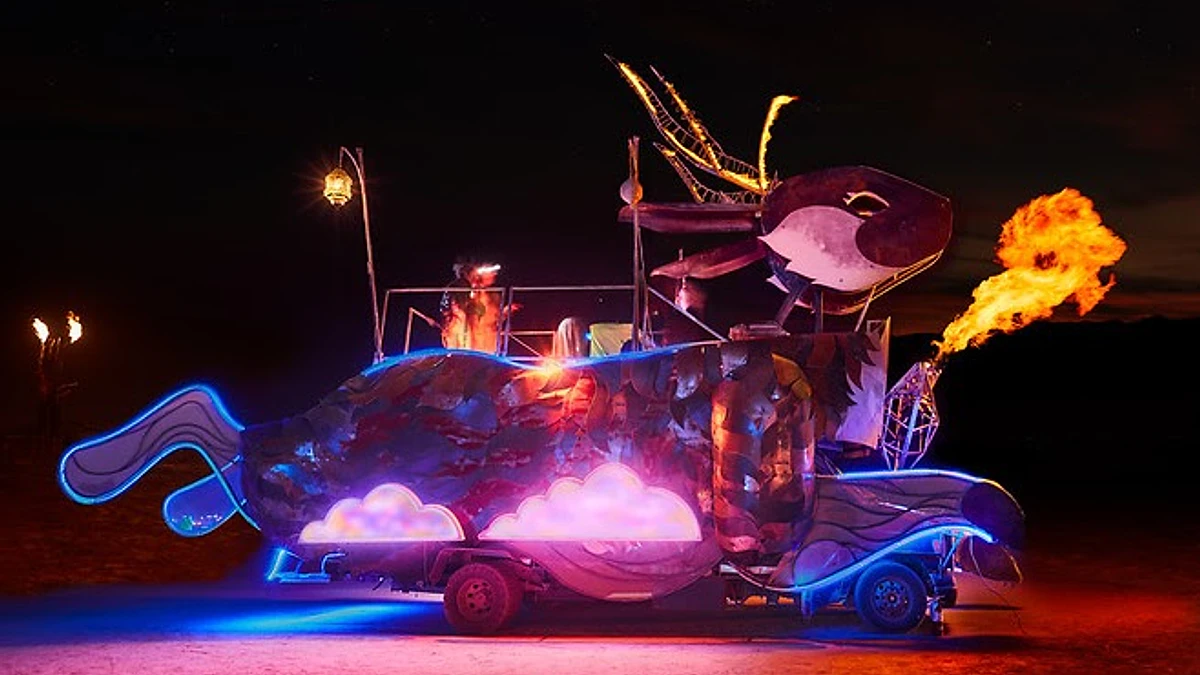 Tarna the Jackalope's full steel body glowing with blue and pink light at night